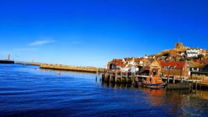 Photograph of Whitby Harbour featuring the pier